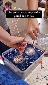 Water marbling art is a delicate technique where artists drip and manipulate vibrant colors on the surface of water to create intricate patterns. These designs are then carefully transferred onto various objects, showcasing the unique beauty of this fluid art form. Artist: @raynbowcrowstudios 🎥 #paint #satisfying #watermarbling | Doesartwork