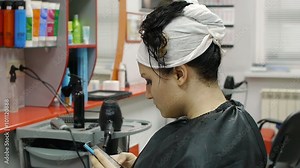 Woman with long hair at the beauty salon getting a blower