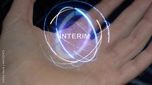 INTERIM text in a round conceptual hologram on a female hand. Close-up of a hand on a black background with future holographic technology