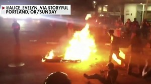Portland demonstrators gather near police precinct, set fires