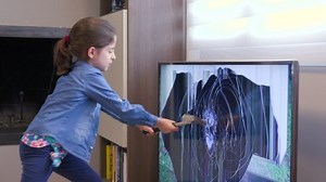 Mad little girl smashing LCD TV set screen with hammer. Crazy female child hitting television monitor with tool for rage and violence