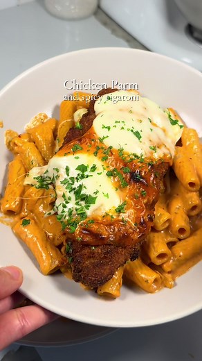 Chicken Parm and Spicy Rigatoni 🍝 perfect combination, perfect dinner 🤭 Full recipe in bio! Save this for your next pasta night ❤️ Ingredients Spicy Rigatoni Pasta - 1/2 white onion, chopped - 2 tbsp minced garlic - 2 tbsp tomato paste - 2 cups heavy cream - 2 tbsp red pepper flakes - 1 tbsp oregano - 1 tsp salt - 1/2 tbsp garlic powder - 1/2 tbsp onion powder - Rigatoni - Parmesan Chicken Parm - Chicken breast, sliced and beaten thin - Eggs - Flour - Breadcrumbs - Mozzarella - Pasta sauce fro