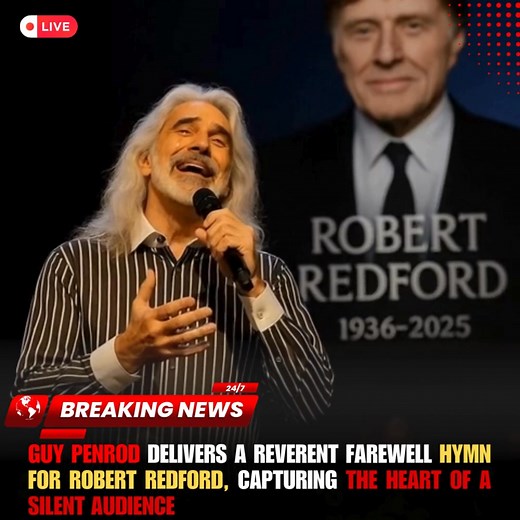 Under the dim glow of the stage lights, before a hushed auditorium, Guy Penrod stepped forward with quiet reverence. The vast performance hall, moments earlier alive with conversation, fell into complete silence as he clasped the microphone with both hands. With a voice rich in emotion and depth, Penrod began to sing a farewell hymn, paying tribute to Hollywood legend Robert Redford, who had passed away at 89. The solemnity of the moment was palpable as Penrod’s voice carried through the auditor