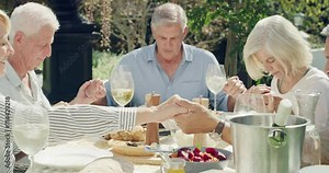 Praying, lunch and old people holding hands, garden and summer break with reunion, spiritual and food. Brunch, senior men or mature women with peace, friends and social gathering with joy or party