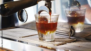 Decaf cold brew being filled with a coffee maker machine, close up shot