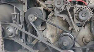 The car engine is running on a belt system.