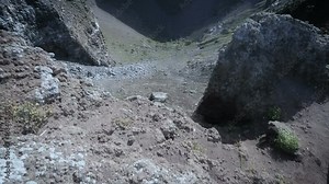 Person looking down from cliff edge and making steps back forth, vision doubling Stock Video