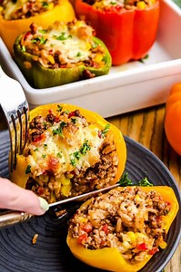 These bell peppers are stuffed with a delicious cheesy ground beef and rice mixture. Super easy to make and they're ready in about an hour! https://thestayathomechef.com/stuffed-bell-peppers/ | The Stay At Home Chef