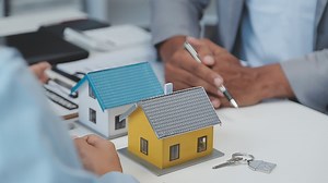 Download Real estate agent and customer signing contract to buy house, insurance or loan real estate.rent a house,get insurance or loan real estate or property. for free