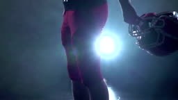 Boy rugby player holding a red protective helmet and shakes it to the...