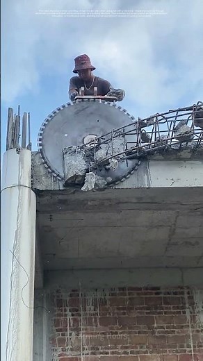 Worker Operates Circular Saw Cutter to Cut Reinforced Concrete on Building Structure