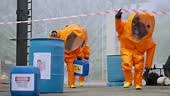 Hazardous Materials and Toxic Disposal Teams collect spilled toxic...