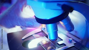 Microscope Analysis of Chemical Samples in a Purple Lit Laboratory