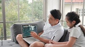 On the couch in the living room, an Asian family embraces e-learning. The father's laptop aids in teaching, fostering a happy home study environment