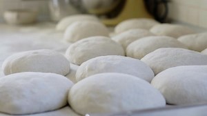 Close up of sourdough bread dough loaves rising on the bench