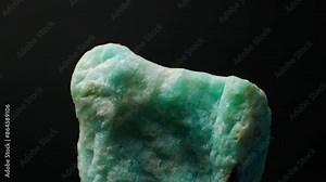 Amazonite ((K,Na)AlSi3O8) Mineral. Source (ore) of Rubidium and Cesium. Vibrant green to blue-green hues and smooth texture. Significance in gemology. Close-up smooth rotaion. Green variety Stock Video
