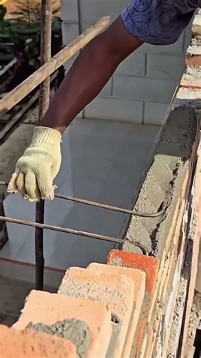 the stage of installing several pieces of iron on the top of the wall which are used as supports