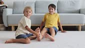 Happy positive children, tickling on the feet, having fun together,...