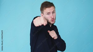 Fist fight. Aggressive man. Hand combat. Boomerang animation. Angry guy punch boxing with clenched knuckles isolated on blue background GIF loop motion.