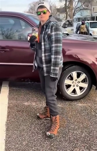 Newly released cellphone video filmed by the ICE agent himself shows a different angle of the fatal shooting of Renee Nicole Good, the 37 year old woman killed in Minneapolis. The footage captures the moments leading up to the shooting from the agent’s perspective. Renee Good is behind the wheel of a maroon Honda SUV. Her wife exits the vehicle and begins filming. A dog is visible in the back seat. At one point, Good calmly says through the open window, “It’s fine, dude. I’m not mad at you.” The