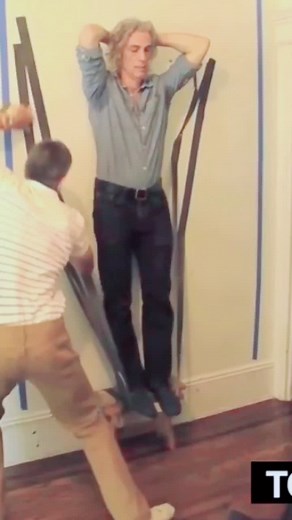 Fastest time to duct tape a person to a wall: 26.69 secs by Ashrita Furman 🇺🇸
