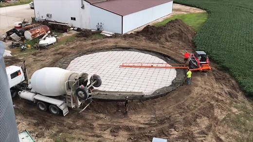 Laying the concrete of a new grain bin #dragonscreed #pourmore #concrete #construction #screeding #concretefinisher #concretelife #flatwork #pourconcrete #pouringconcrete #concretetruck #skidsteerattachments #concretescreed #concreteslab #concretefinishing #grading