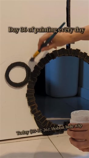 Day 36 of painting every day. Something completely different today! Making a Hobbit hole in my laundry door, because my cats need access to it, and just a regular hole is boring. Sanded it down first and gessoed it. Didn't quite cover enough, and I could very much feel the areas that didn't get the gesso, the paint didn't stick as well. The floppy crooked lower right bit of the hole will be fixed when I get to the other side of the door, so that's a worry for later. #lordoftherings #diy #cat | A