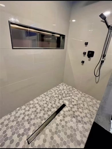 Full shower flip 🚿✨ From a basic shower to a clean, modern upgrade. ✔️ Large-format wall tiles ✔️ Hexagon mosaic floor with linear drain ✔️ Built-in shower niche with LED lighting ✔️ Matte black shower system, including handheld shower with wall outlet Every detail was carefully planned for style, function, and durability. Swipe through the transformation 👀 #renovation #bathroomremodel #steptorestrenovation #basmentremodel | Step to Rest renovation inc