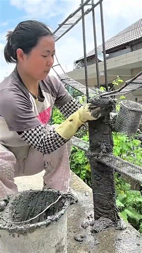 She shapes steel wire and adds cement to form sturdy garden stair posts neatly and safely