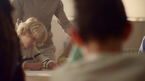 Students making notes in exercise books at table. children doing class work Free Stock Video Footage