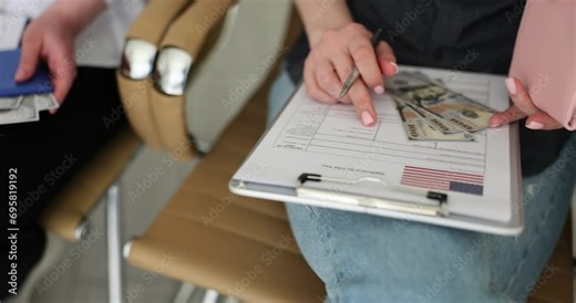 Closeup of group of people filling out US visa application form. Student Residence Permit in USA