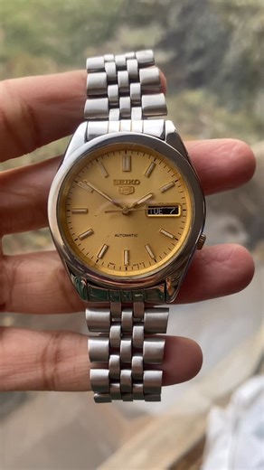 Mohd Anas on Instagram: "Price 4850/- DM to Buy. Brand/Model: Vintage Original Seiko 5 Cal 7S26 Movement: Automatic 21 jewels (no battery needed—self-winding) Case Size: 37mm (vintage standard, wears well on most wrists) Case Material: Stainless steel, Glass Back Dial : Golden Face With Lume Figures Functions: Day-Date complication at 3 o’clock (shows both day of the week and date) Bracelet: Usually stainless steel, sometimes paired with period-correct Bracelet Origin: Made in Japan We are the V