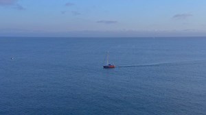 A sailboat sailing through the blue sea, aerial view - Free Stock Video