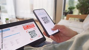 Woman scanning invoice qr code and confirming with fingerprint for online payment. Paying and approving identity with secure biometric technology