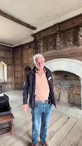 Join us inside Stokesay Castle’s solar with volunteer, Steve 🔑🏰 Video description: A volunteer in an English Heritage uniform stands in an impressive historic room with original wood panelling. The room features an ornate fireplace with engravings and traditional wooden furniture, as well as two symmetrical ‘peepholes’ which look down into Stokesay Castle’s Great Hall - a vast medieval hall with a vaulted ceiling and beams. The video pans around to each different feature of the room, as descri