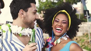 Carnaval Party in Brazil, brazilian couple and friends having fun at parade festival in costume