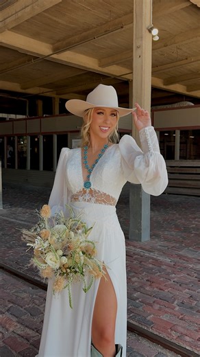 Birdie Bridal on Instagram: "Xoxo, your western bride 🤍🤠 Model: @__morgannicole Dress: @birdiebridalfw Hair & Makeup: @rwn.beauty Jewelry: @sunwesthandmade Hat: @baileyhatcompany Boots: @libertyblackboots Photographer: @poppiesandpinesphotography Florals: @angelicgardenflorist Venue: @cowtowncoliseum #westernbride #texasbride #westernwear #westernwedding #stockyards #fortworthstockyards"