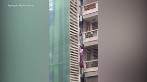 Video: Families forced to climb down high-rise building during fire