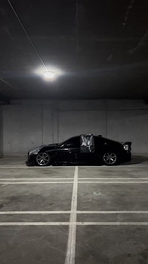 Sleek Black Sports Car with Intricate Graphic Wrap