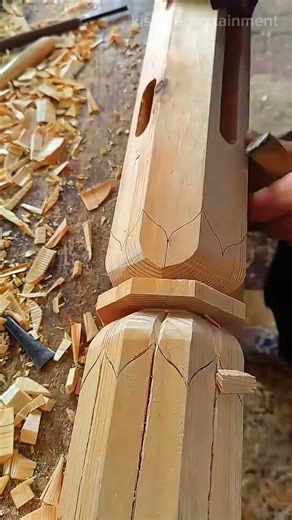 Carving intricate lotus flower patterns on a large wooden pillar with a sharp manual chisel tool