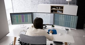 clip-1099129399-using-corporate-invoice-spreadsheet-on-computer-monitors