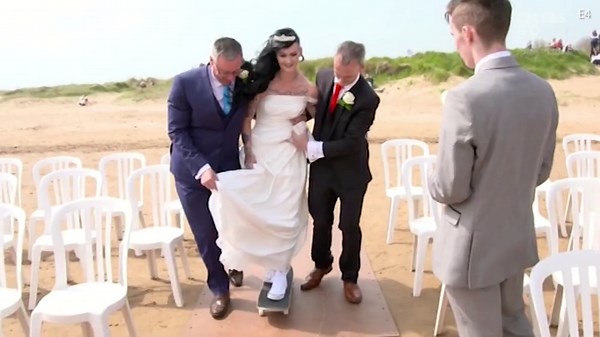 Bride struggles to skateboard down the aisle for her wedding