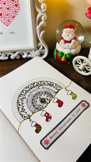Ankita ｡𖦹°‧ on Instagram: "Tiny Christmas socks hanging on mandala magic 🎄🧦 Little festive details, warm vibes, and lots of holiday joy tucked into this page ✨💗 Sketchbook @menorahcreatif ✨ . . . . christmas mandala art, festive mandala illustration, cute stocking doodle art, holiday mandala design, christmas socks illustration, handdrawn festive mandala, cute christmas mandala, aesthetic holiday doodle, mandala with festive elements, christmas themed mandala art, cozy christmas illustration