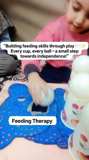 > “Building feeding skills through play 🍽️✨ Every cup, every ball – a small step towards independence!” The child is participating in a feeding therapy–based fine motor task. She’s picking up and placing soft balls or objects on paper cups — this helps improve hand-eye coordination, grip strength, and motor planning, which are all important for developing self-feeding skills. 💡 Therapeutic Goals Improve fine motor control and bilateral hand coordination Encourage focus and sitting tolerance St