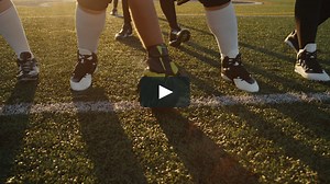 Close up of a football center hiking the ball to the quarterback | Vimeo Stock