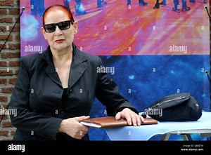 Photo and video artist Katharina Sieverding poses in front of a video image of herself during the press conference about her exhibition at Museum Schloss Moyland in Bedburg-Hau, Germany, 25 July 2013. The exhibition "Weltlinie 1968 - 2013" runs from 28 July until 24 November 2013. Photo: HORST OSSINGER Stock Photo - Alamy