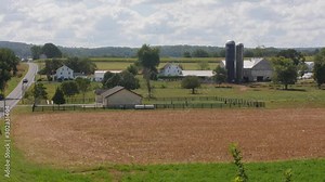 Amish One Room School House with Children Playing During Recess on a Sunny Day