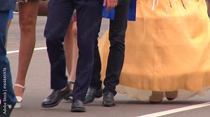 Parade of girls in beautiful dresses on city festival