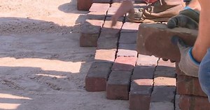 Bricks on Saginaw Street being re-laid after contractors used wrong kind of sand