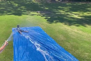 Hot day = Homemade Slip n’ Slide. #Tarp #Soap #Hose #HoursOfFun ☀️ | Cheryl Preheim